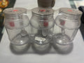 Four clear glass bottles with metal caps 