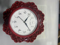 Decorative wall clock with a red floral frame