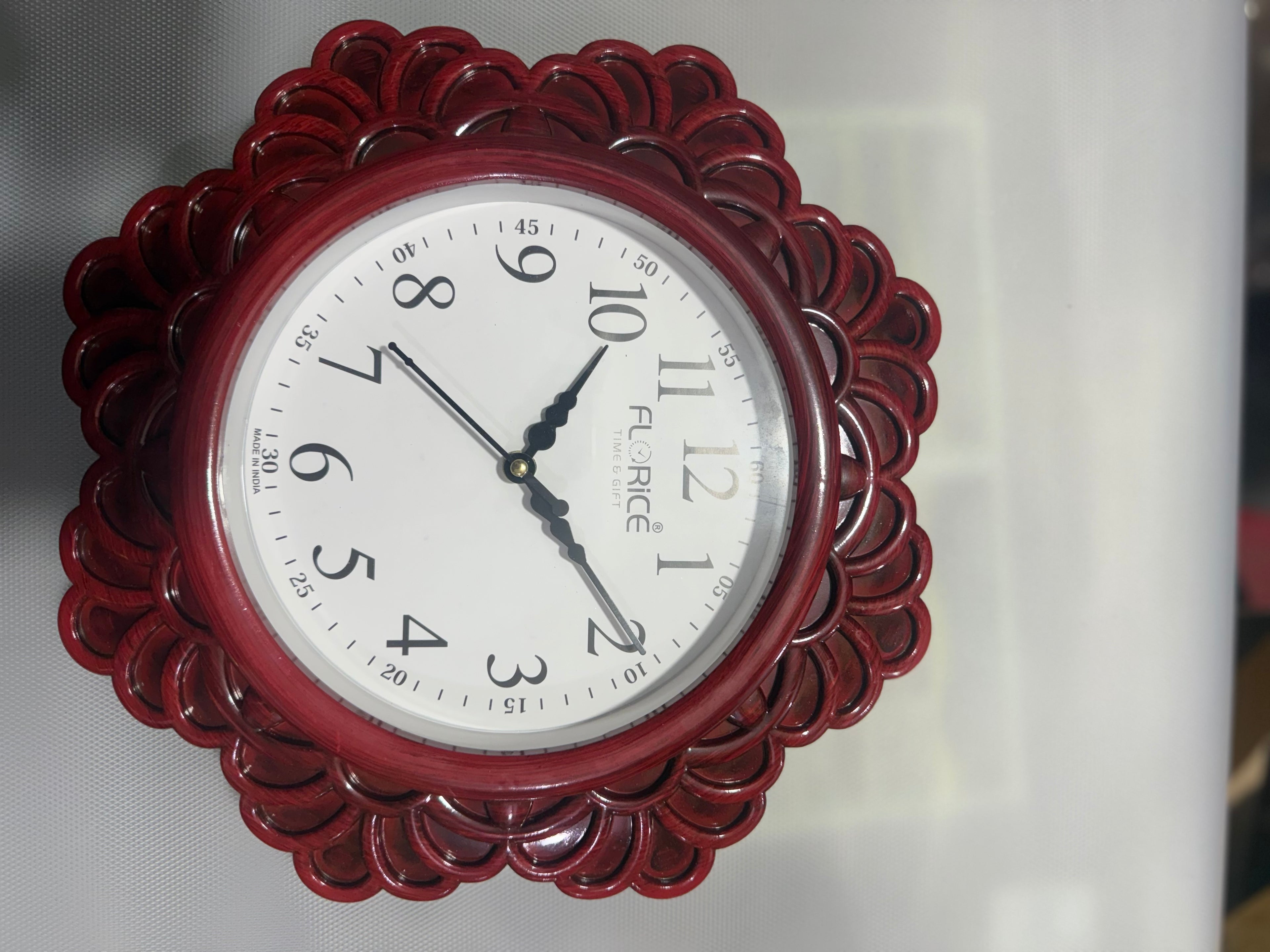 Decorative wall clock with a red floral frame