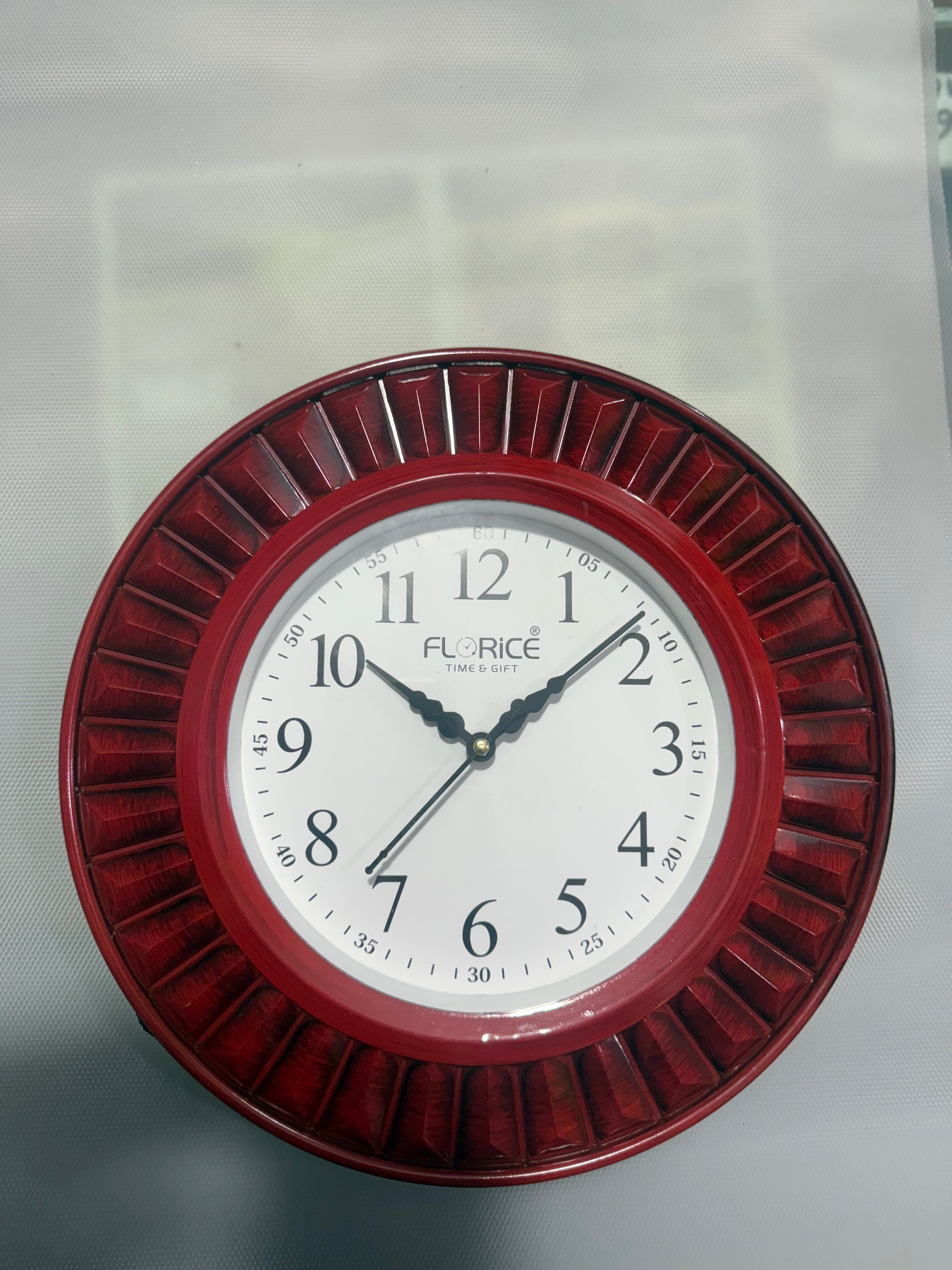 Round wall clock with red metallic frame